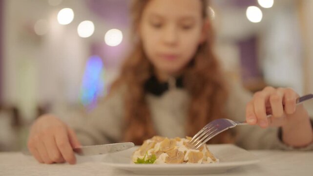 Beautiful teen girl eats salad with champignons and mayonnaise