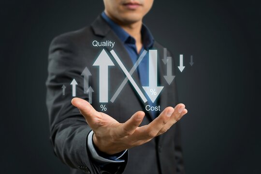 Businessman presenting a digital chart showing increased quality and decreased cost metrics
