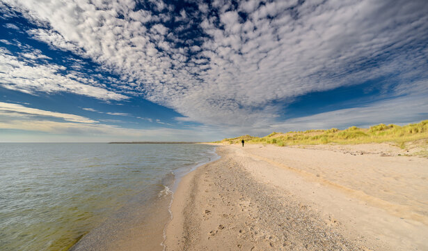 Lonely figure enjoying the beautiful beachscape in Holland.