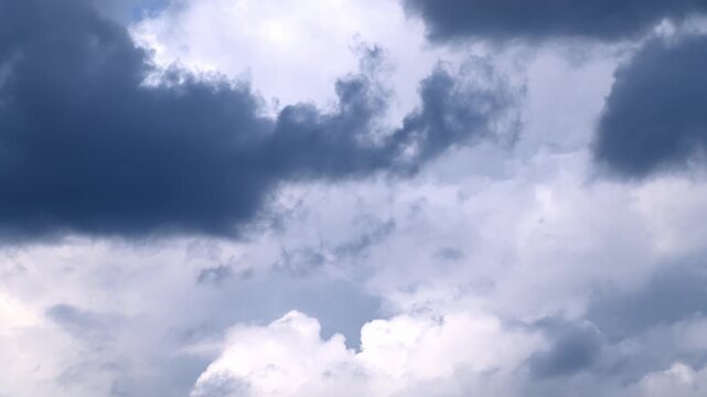 Dark storm clouds rolling across open sky before storm, timelapse