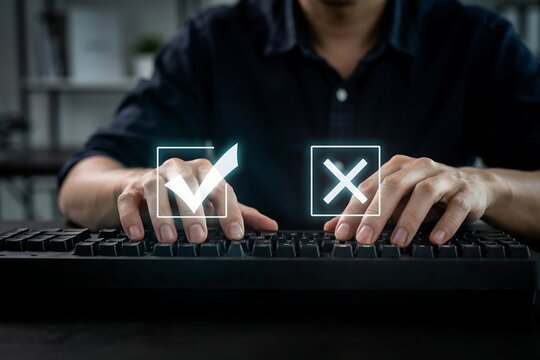 Person typing on a computer keyboard choosing between correct and incorrect checkmark icons