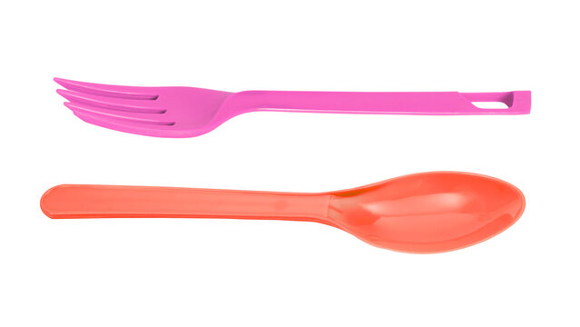 Pink plastic fork and red plastic spoon isolated on transparent background