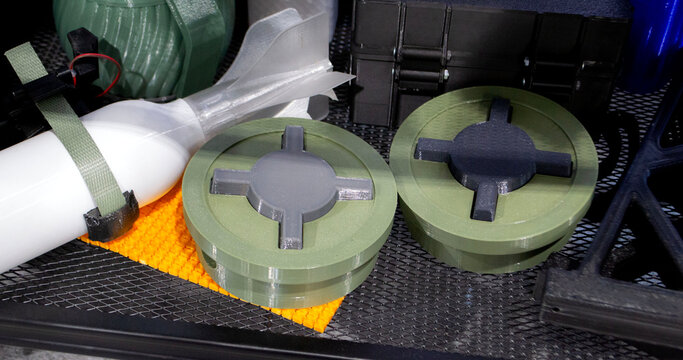 Anti-personnel high explosive mine printed on 3D printer. Mine created on 3D printer from molten plastic. Prototype of ammunition printed on 3D printer. Innovation modern new 3d printing technology