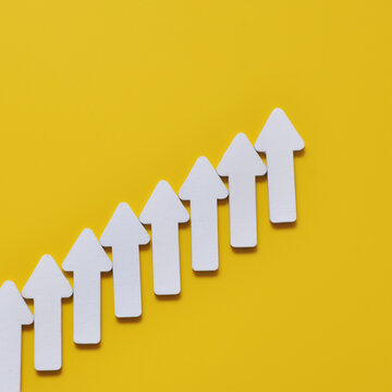 White arrows pointing upward representing business growth and progress