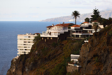 Luxury villas perched on volcanic cliffs above the Atlantic Ocean in Tenerife © Gabriela