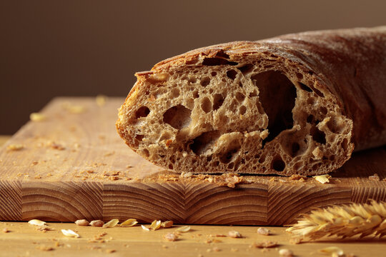 Ciabatta bread, Italian bakery food on a wooden table.