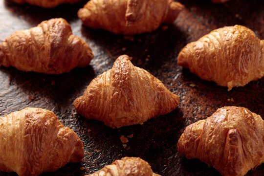Croissants on a brown vintage background.