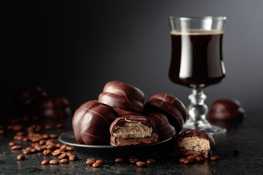 Chocolate-covered coffee souffl&eacute; cookies and cup of black coffee.