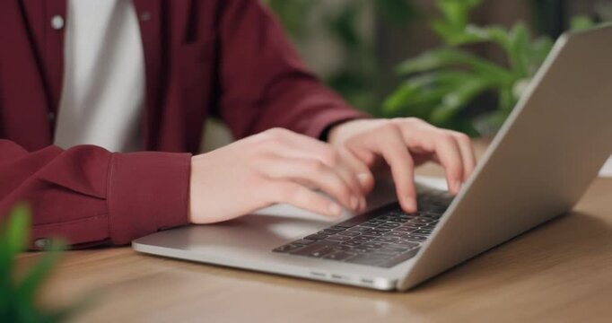 Hands typing on laptop keyboard during remote work day