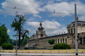Fototapeta premium Magnificent baroque palace with ornate crown pavilion and large courtyard under beautiful dramatic cloudy sky