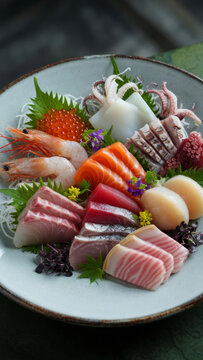Exquisite assorted raw fish sashimi set elegantly served in a traditional ceramic bowl