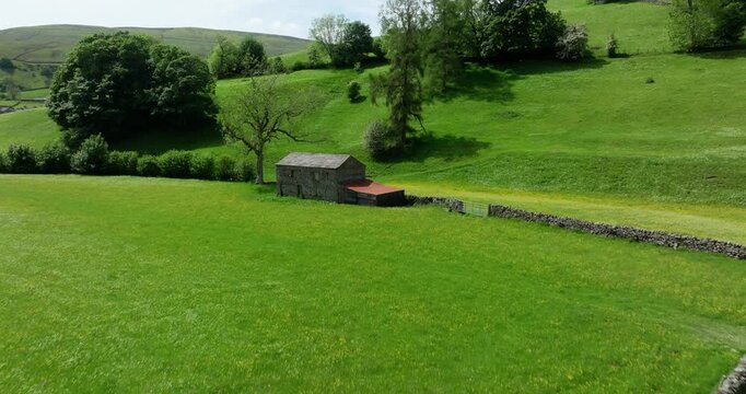Aerial shot of a barn in the wildflower meadows