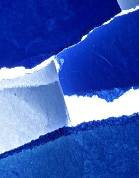 Layered Blue Torn Paper Texture Arrangement on White Background