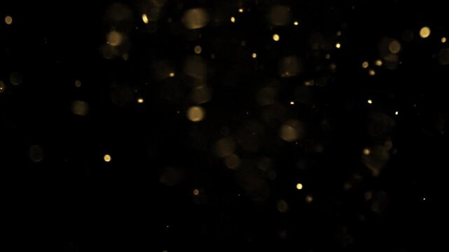 Gold ink in water shooting with high speed camera. Gold glitter background with sparkle shine light confetti. Super Slow Motion at 1000fps. effect.