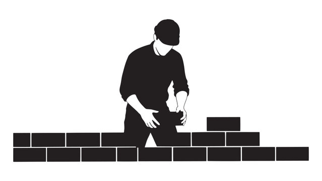 Construction worker installing bricks on a masonry wall at a building site during renovation