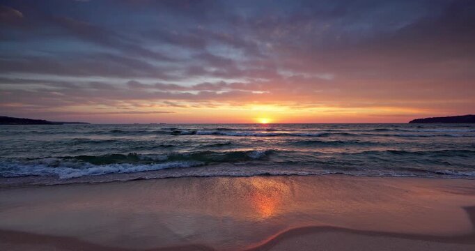 Scenic sunrise over calm sea waves on a sandy tropical beach Dominican republic