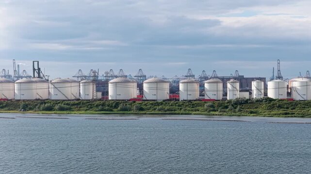 Aerial drone view of industrial oil and fuel storage tanks. Large containers and facility infrastructure for petroleum products and energy resource reserve.