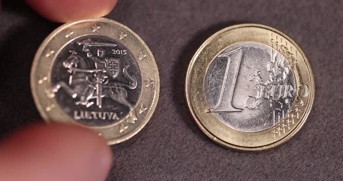 one coin of the European Union with a face value of one euro, metal money worth one euro made of combined metals, close up