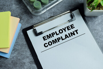 Concept of employee complaint write on clipboard isolated on Wooden Table. For human resource...