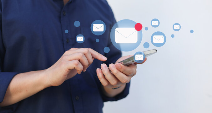 close up businessman holding smartphone and checking email online on web with virtual interface technology concept