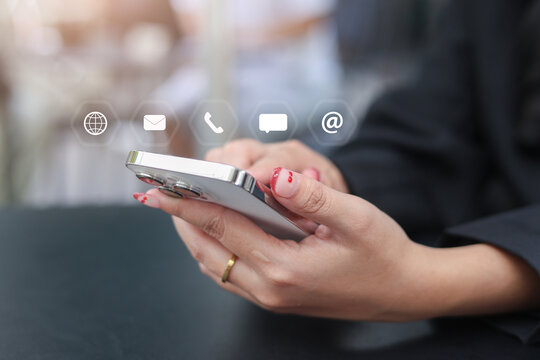close up woman holding smartphone with virtual interface icon of helpdesk service and support for cintact us concept