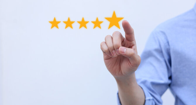 close up on customer man hand give gold five star rating feedback icon and press level three rank (good) for give score point to review the service business concept