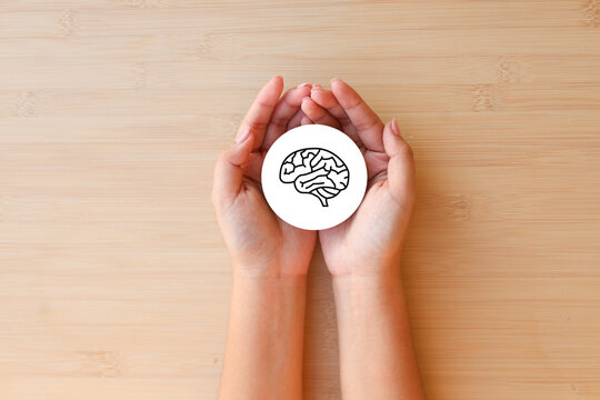 close up top view on pediatrician woman hand show symbol of brain for adhd , dementia and alzheimer therapy concept
