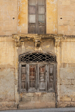 Weathered Wooden Door and Window on Historic Maltese Building