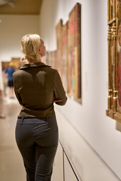Caucasian woman looking at exhibition
