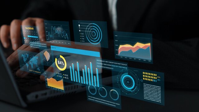 Business Professional Analyzing Digital Data with Advanced Analytics Visuals on a Laptop in a Modern Office Environment. Entropy.