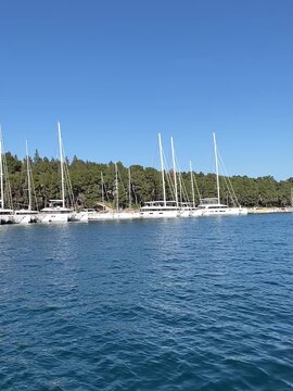 Yachts tied up in the harbor on a calm and sunny day. Boat harbor on the island of Hvar. Relaxed travel and vacation concept.Used for summer tourism promotions.FullHD footage