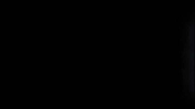 Smoke atmosphere or fog overlay on black background, vfx compositing and fog effect use, white fog cloud motion graphic on dark background, slow motion of steam rising up, 4k loop
