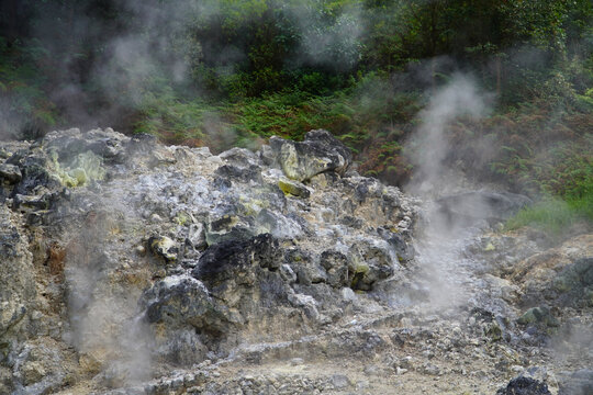 Bandung, Indonesia - July 4, 2026: Steam rises from the geothermal vents at Rengganis Crater in Ciwidey, Bandung, West Java, Indonesia. The volcanic tourist attraction is known for its natural hot spr