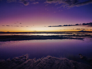 Fototapeta premium Stunning purple and orange twilight sky reflecting on a serene lake in South America landscape