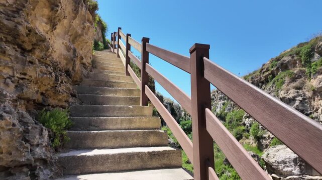 Wied il Mielah, Gharb, Gozo - Going up the stairs of Valley near limestone natural arch on the north-western coast of the island of Gozo in Malta. High quality 4k footage