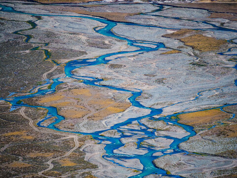 Aerial view of a winding braided river system flowing through the arid landscape of South America