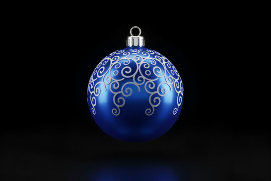Blue Christmas ornament with silver scroll pattern hanging during festive season