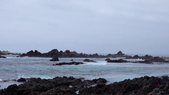 Pacific Ocean waves crashing against rocky coastline in Ilo Peru