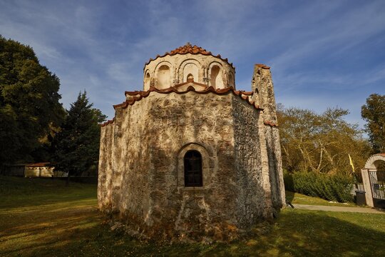 Old stone church with a simple design, in a wooded setting under a blue sky, Byzantine chapel of Agios Nikolaos Foundoukli, between Eleousa and Profitis Ilias, Rhodes, Dodecanese, Greek Islands, Greece