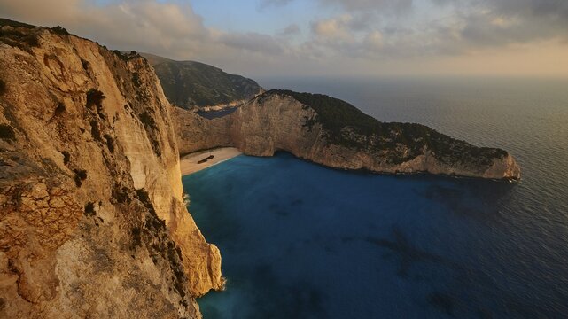 Paralia Navagio, Shipwreck Beach, shipwreck MV Panagiotis, winter, rocky cliff, cloudy sky, deserted beach, blue and turquoise crystal clear sea, Zakynthos, Ionian Islands, Greece