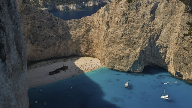 Paralia Navagio, Shipwreck Beach, rocky cliff, shipwreck MV Panagiotis, many tourists on the beach, excursion boats, blue and turquoise crystal clear sea, Zakynthos, Ionian Islands, Greece