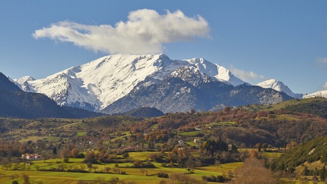 Idyllic landscape with snow-capped mountains, bright autumn colours and a single cloud, Erymanthos Mountains, northwest of the Peloponnese peninsula, Peloponnese, Greece
