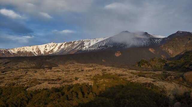 Snow-capped Etna peaks, volcano in soft morning light, snow-covered, occasional clouds in the sky, UNESCO World Heritage Site Etna, volcano, volcanism, Sicily, Italy