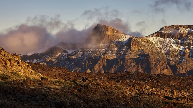 Mirador El Tabonal Negro, caldera, mountain landscape with clouds illuminated in warm light casting shadows over the rocks, Teide, Parque Nacional del Teide, Teide National Park, volcano, volcanism, UNESCO World Heritage Site, Tenerife, Canary Islands, Spain