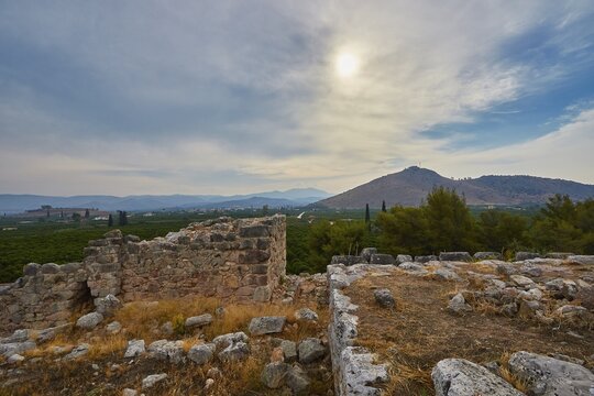 Ancient ruin landscape with a view of a mountain range and cloudy sky in the background, Tiryns, ancient city in Argolis, Mycenaean, Peloponnese, Greece