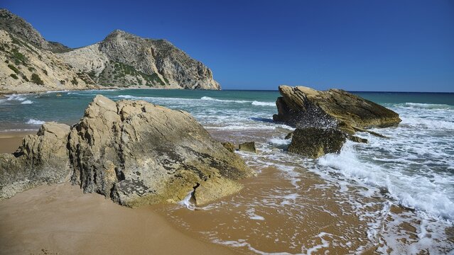 Beach, Kavo Paradiso, Paradise Beach, waves crashing against rocks on a sunny beach, Kefalos, Kos, Dodecanese, Greek Islands, Greece
