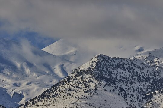 Snow-covered mountain range under a cloudy sky, Lefka Ori, White Mountains, mountain massif, west, Crete, Greece