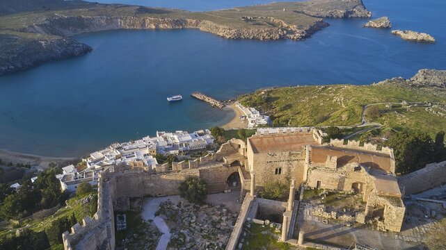 Drone shot, Lindos, late afternoon light, drone view of an old windmill on a rocky shore in the golden light of dusk, Archaeological site, Lindos, Rhodes, Dodecanese, Greek Islands, Greece