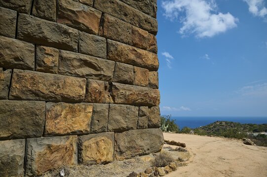 Ancient ruined wall in dry landscape overlooking the sea on a sunny day, Palaiokastro, Ancient fortress, 3rd and 4th century BC, above Mandraki, Nisyros, Dodecanese, Greek Islands, Greece