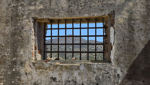 View through a barred window onto a mountain landscape, Old Silk Factory, German Wehrmacht military prison, Concentration Camp, Lost Place, Kattavia, Rhodes, Dodecanese, Greek Islands, Greece